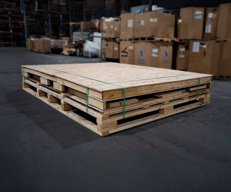 Knock-down wooden shipping crate stacked flat for efficient freight and storage.