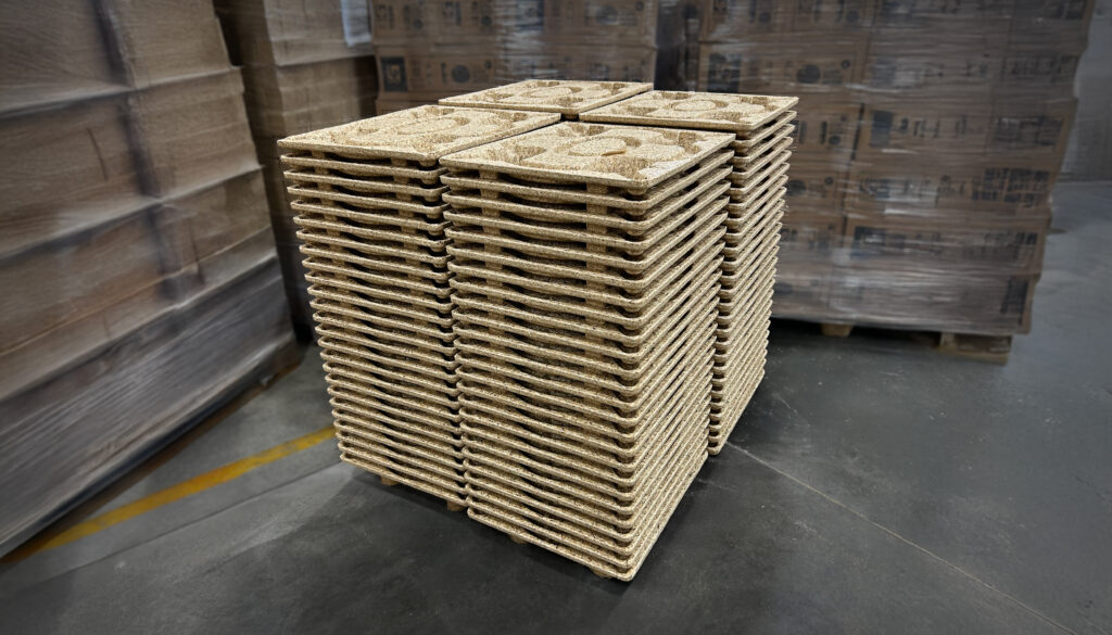 Stacked pressed wood pallets representing sustainable supply chain solutions and ESG-focused logistics