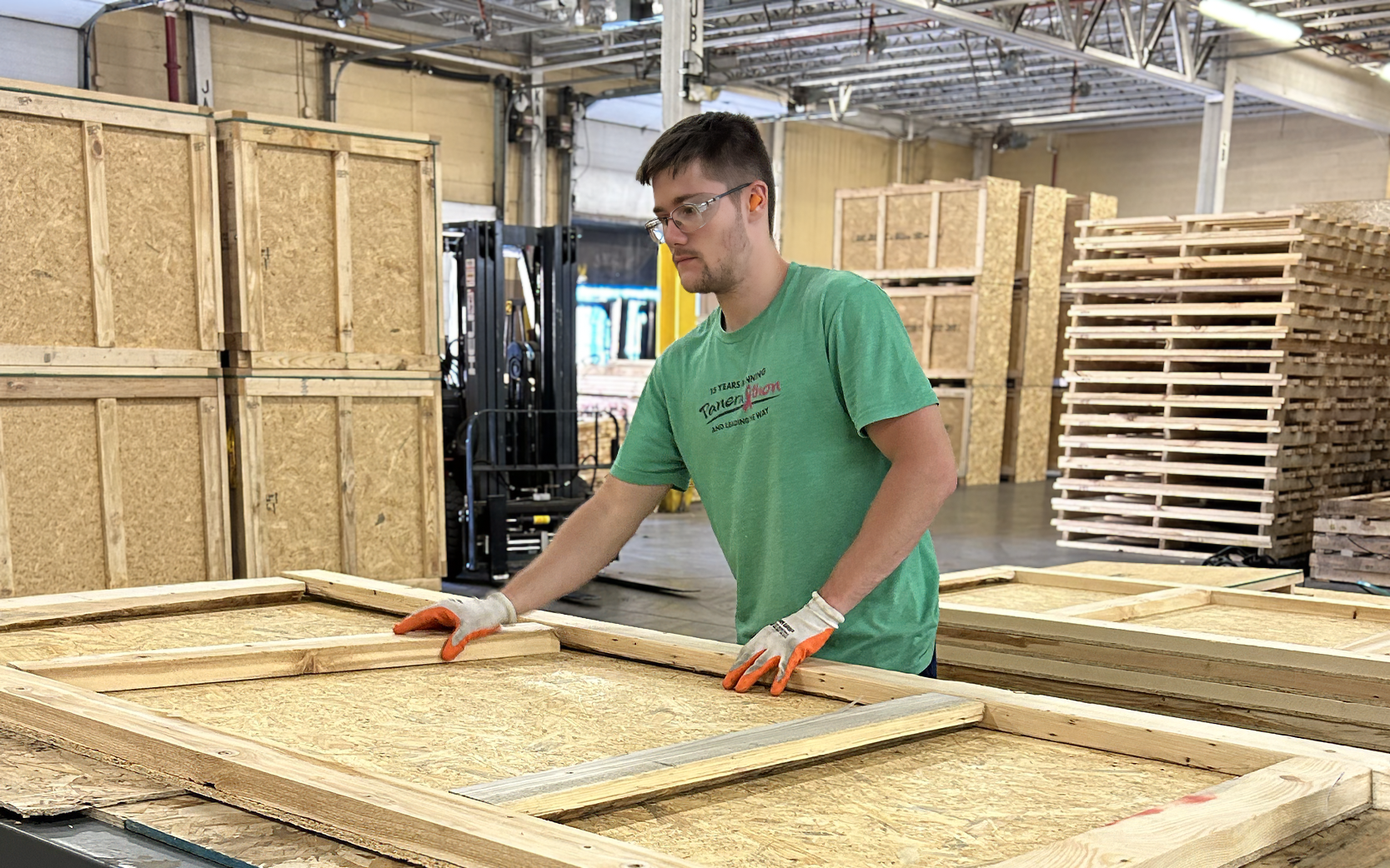 Litco team member assembling a custom wood shipping crate in a manufacturing facility.