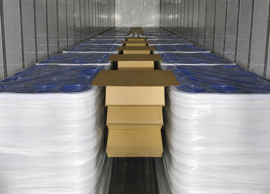 Center Drop Void Filler installed between palletized loads as one of Litco’s packaging options to reduce shipping damage.