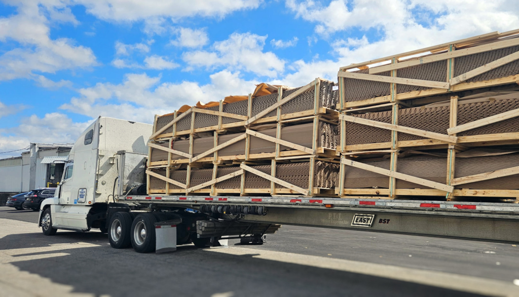 Flatbed truck loaded with 12 custom shipping crates of corner board at Litco and Millwood's Lordstown Ohio production facility.